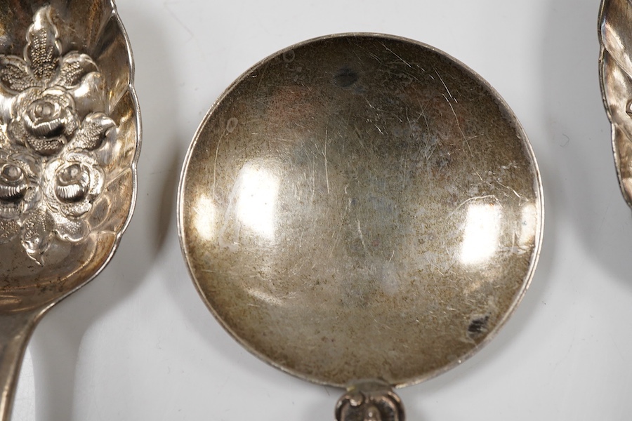 A pair of George III silver gilt Old English pattern berry spoons, London, 1787, 21.8cm, two other earlier silver berry spoons and an Edwardian serving spoon by William Hutton & Sons, London, 1901, 9oz.